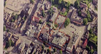 aerial view of town centre site with buildings and car park